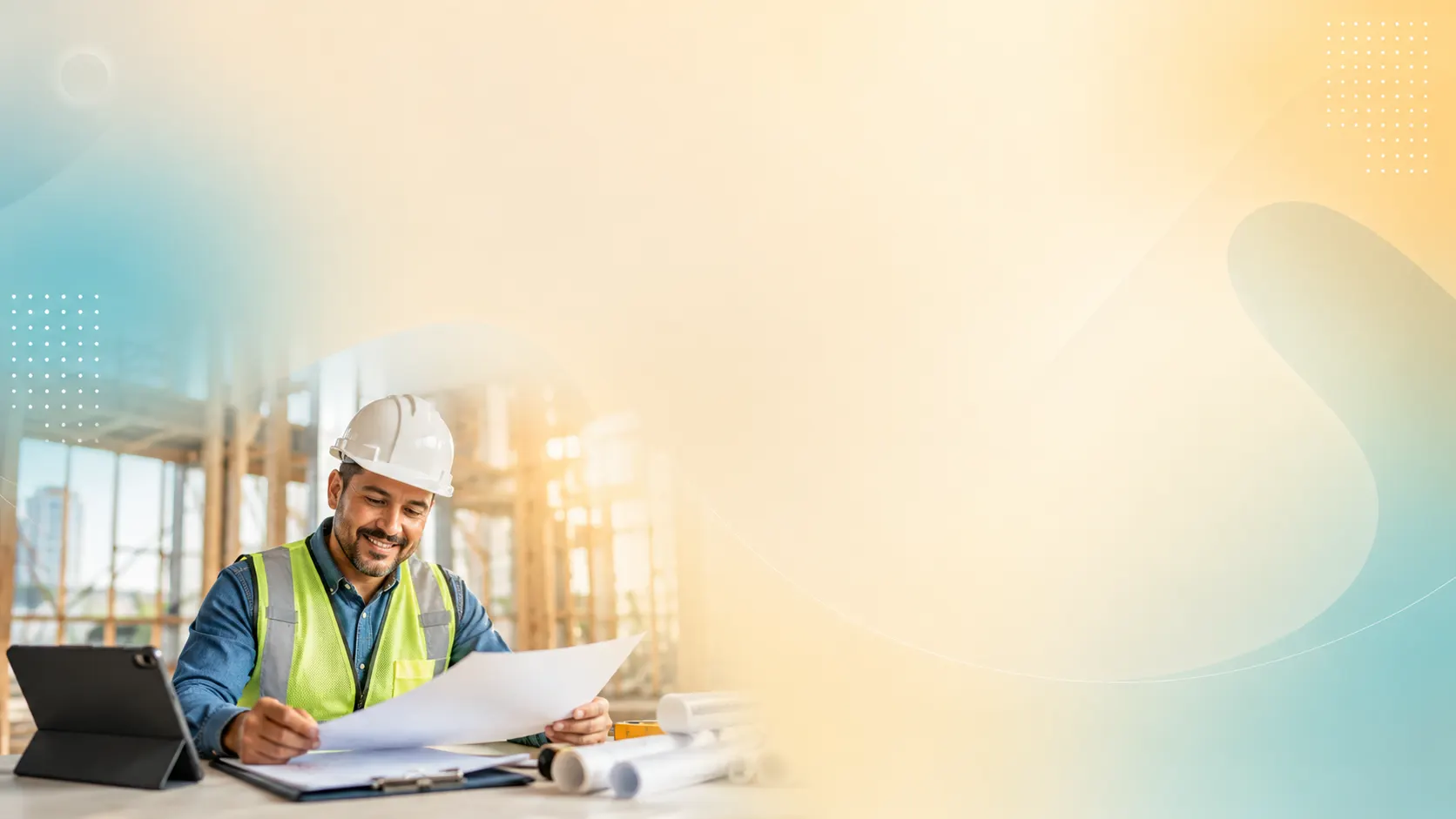 Construction business owner reviewing plans on site